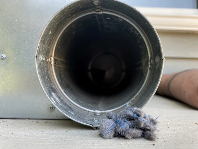 Windsor Locks Dryer Vent Cleaning technician using specialized equipment to clear severe dryer vent blockage in Windsor Locks